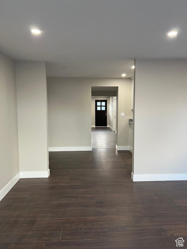 hallway with dark hardwood / wood-style floors
