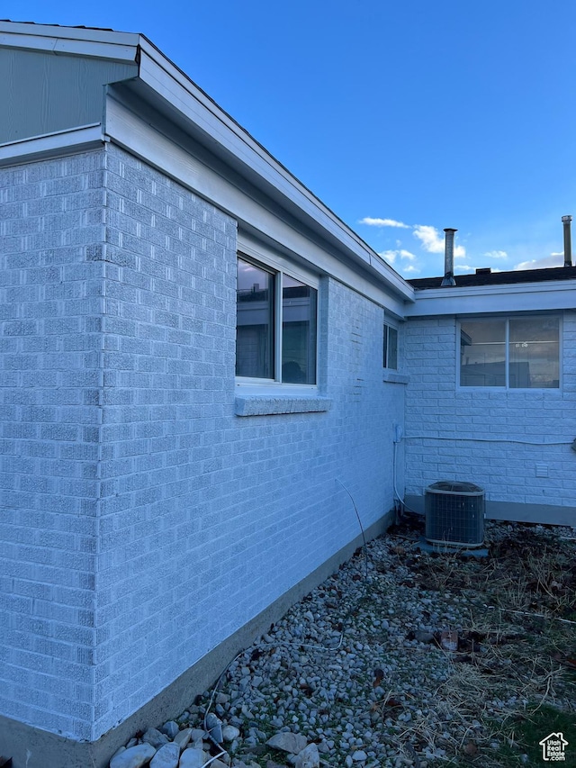 view of side of home with cooling unit