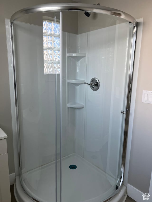 bathroom featuring a shower with door