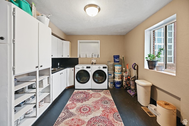 1518 E 9000 N, Preston, ID 83263 - washroom featuring separate washer and dryer, a sink, a textured ceiling, and cabinet space