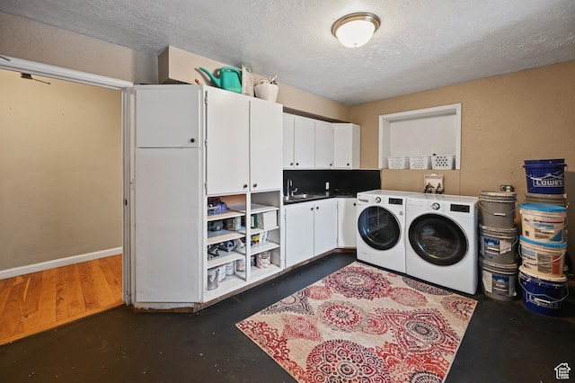 1518 E 9000 N, Preston, ID 83263 - laundry area with cabinet space, a textured ceiling, baseboards, and washer and clothes dryer