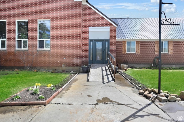1518 E 9000 N, Preston, ID 83263 - property entrance with brick siding, a yard, and metal roof