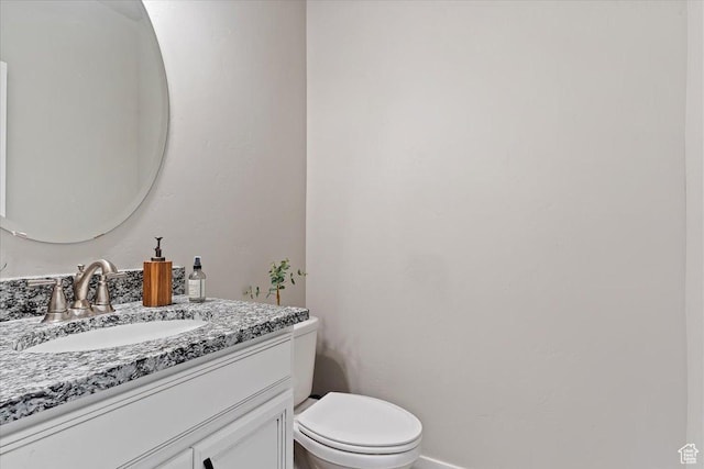bathroom featuring toilet and vanity