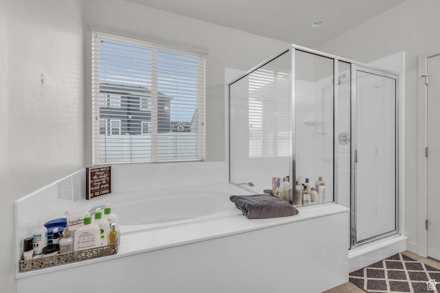 bathroom featuring tile patterned floors and shower with separate bathtub