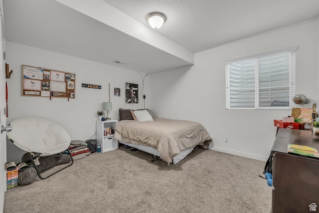 carpeted bedroom featuring a textured ceiling