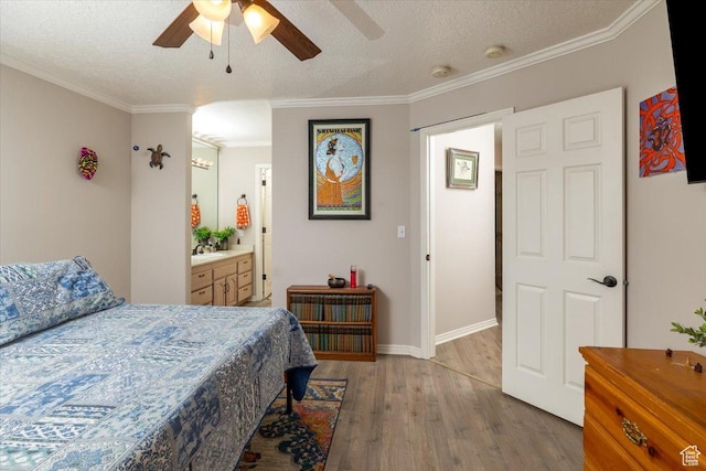 28 N River Pointe Dr, Logan, UT 84321 - bedroom with wood finished floors, crown molding, a textured ceiling, baseboards, and a ceiling fan