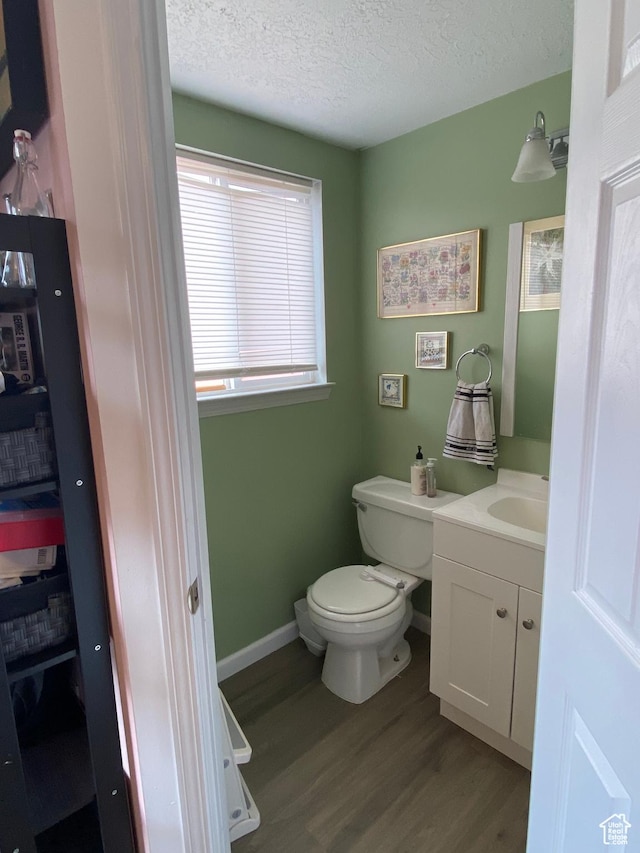 3134 S Buena Verde Ln, Magna, UT 84044 - bathroom with a textured ceiling, toilet, hardwood / wood-style floors, and vanity