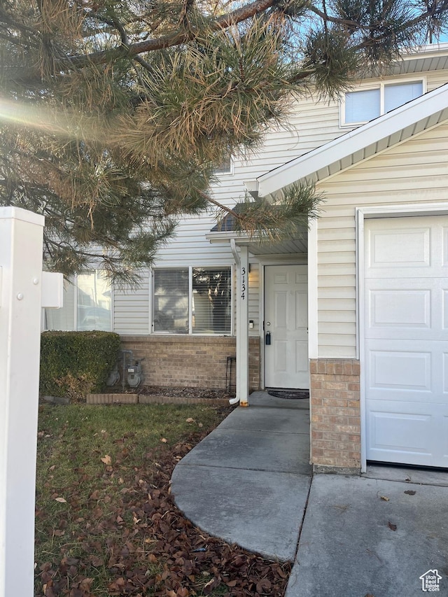 3134 S Buena Verde Ln, Magna, UT 84044 - doorway to property featuring a garage