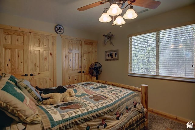2310 S Sweetwater Pkwy Unit 5, Garden City, UT 84028 - bedroom with baseboards, multiple closets, a ceiling fan, and carpet floors