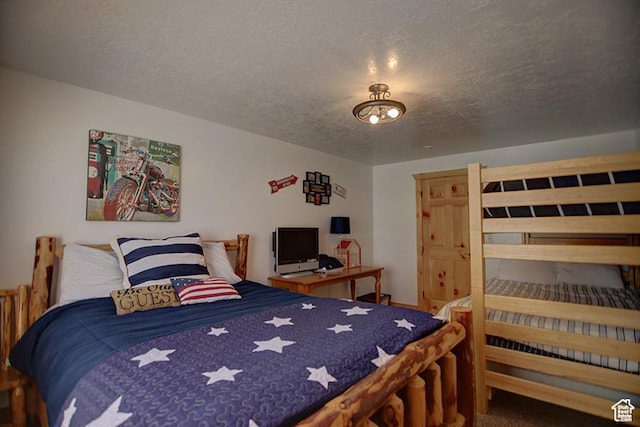 2310 S Sweetwater Pkwy Unit 5, Garden City, UT 84028 - bedroom featuring a textured ceiling and carpet floors
