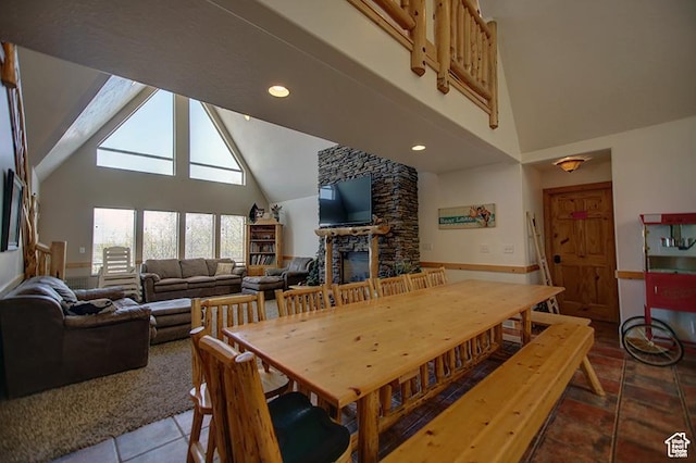 2310 S Sweetwater Pkwy Unit 5, Garden City, UT 84028 - tiled dining space with high vaulted ceiling, a fireplace, and recessed lighting
