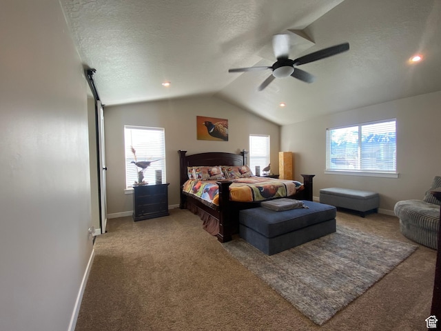 carpeted bedroom featuring a textured ceiling, ceiling fan, and vaulted ceiling