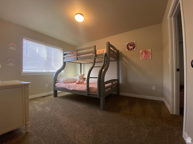 bedroom with dark colored carpet