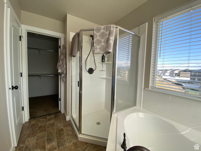 bathroom with separate shower and tub