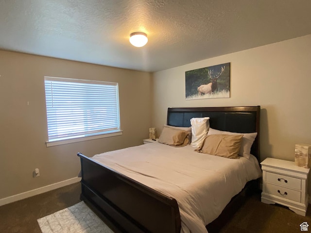 carpeted bedroom with a textured ceiling