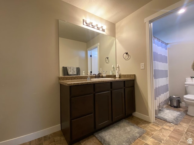 bathroom featuring vanity, toilet, and curtained shower