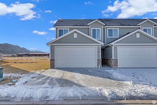 craftsman-style house with a mountain view and a garage