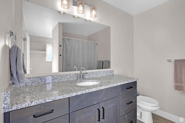 bathroom featuring hardwood / wood-style flooring, vanity, toilet, and a shower with curtain