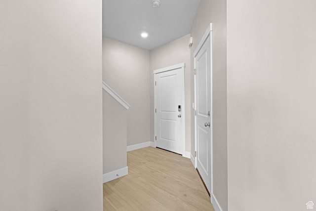 corridor with light hardwood / wood-style flooring