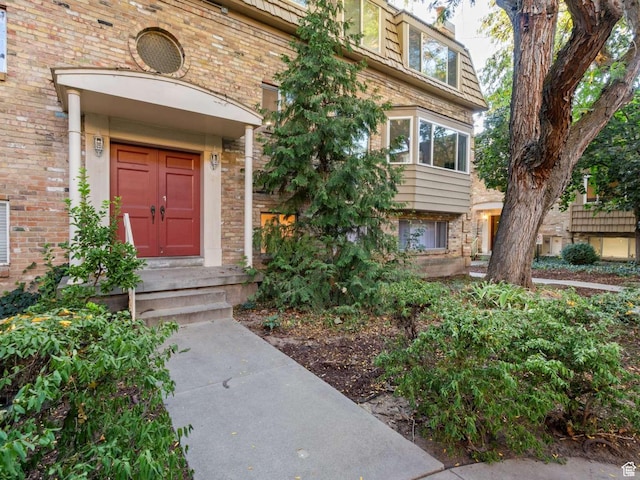 2220 E Murray Holladay Rd Unit 122, Salt Lake City, UT 84117 - property entrance with brick siding and mansard roof