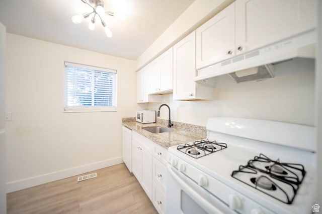 2220 E Murray Holladay Rd Unit 122, Salt Lake City, UT 84117 - kitchen with white appliances, a sink, under cabinet range hood, light wood finished floors, and light stone counters