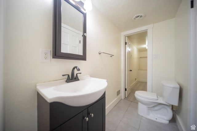 2220 E Murray Holladay Rd Unit 122, Salt Lake City, UT 84117 - bathroom featuring toilet, vanity, tile patterned floors, and baseboards