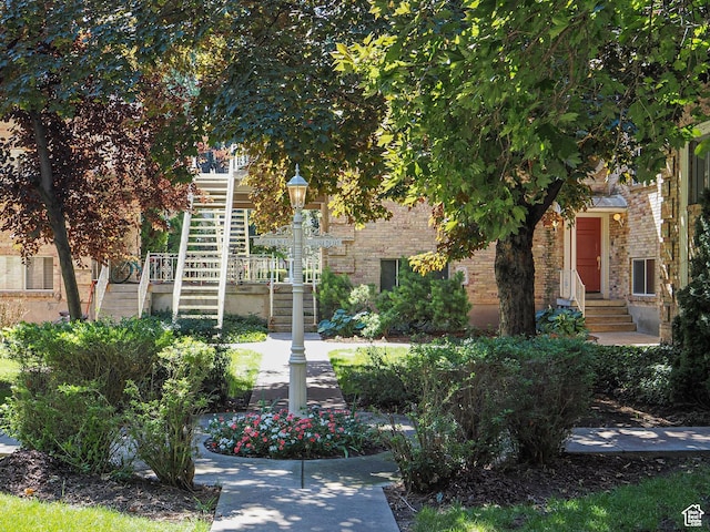 2220 E Murray Holladay Rd Unit 122, Salt Lake City, UT 84117 - obstructed view of property with stairs and brick siding