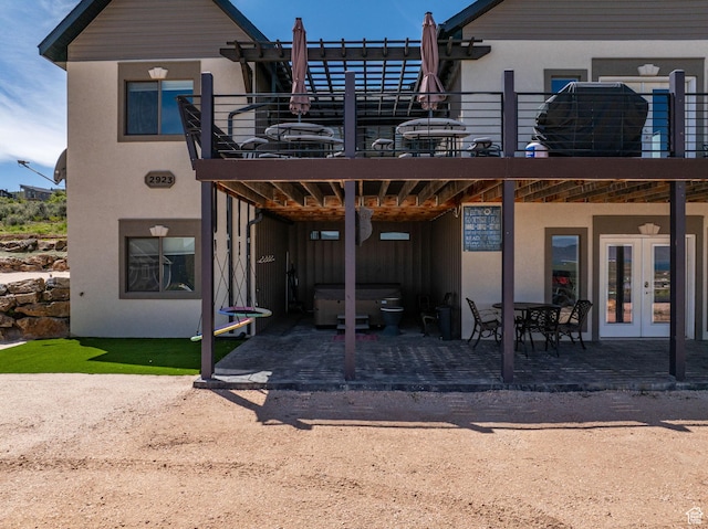 2923 S Country Club Way Unit 46, Garden City, UT 84028 - rear view of house featuring a hot tub, french doors, stucco siding, and a patio area