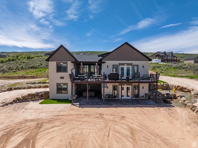 2923 S Country Club Way Unit 46, Garden City, UT 84028 - rear view of house featuring french doors, a patio, a wooden deck, and stucco siding