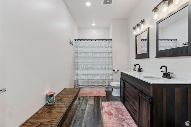 2923 S Country Club Way Unit 46, Garden City, UT 84028 - full bath featuring toilet, wood finished floors, double vanity, recessed lighting, and a shower with shower curtain