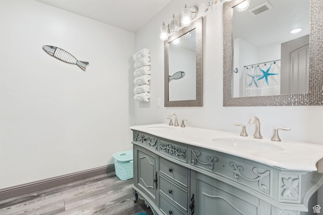 2923 S Country Club Way Unit 46, Garden City, UT 84028 - bathroom with wood finished floors, double vanity, and baseboards