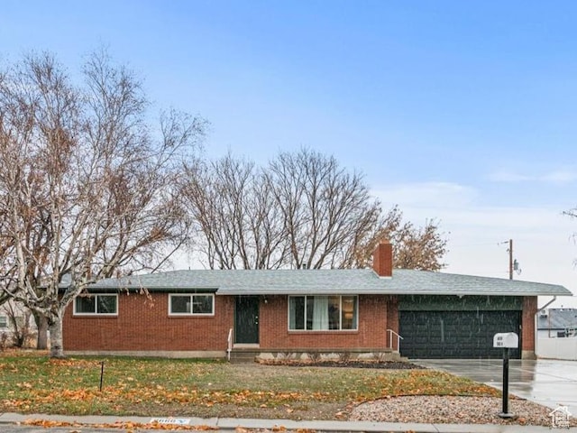 ranch-style house featuring a garage and a front yard