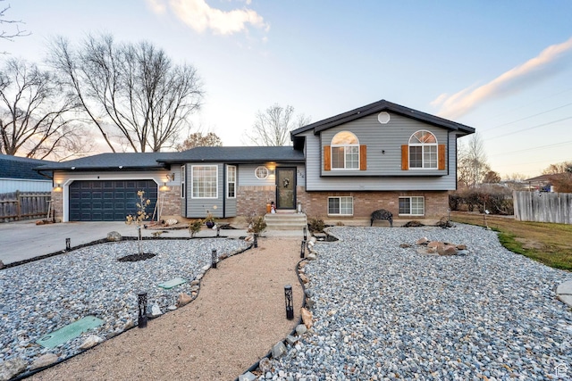556 W 1050 N, Pleasant Grove, UT 84062 - tri-level home with driveway, an attached garage, fence, and brick siding
