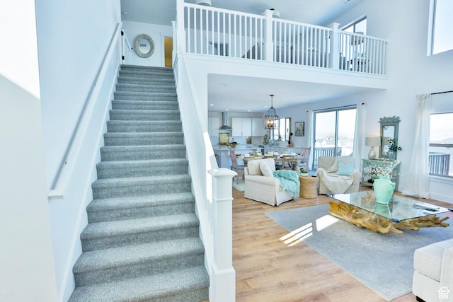 3234 S Iron Hill Cir S, Saratoga Springs, UT 84045 - staircase with a towering ceiling, wood finished floors, and a chandelier