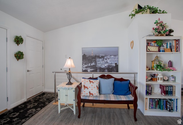 sitting room with baseboards and wood finished floors
