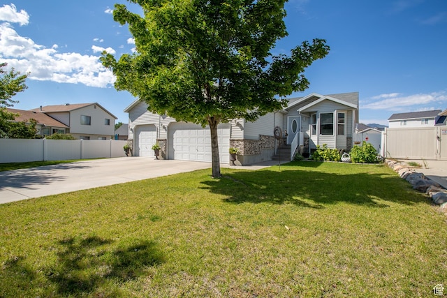 view of front of home with a garage, fence, a front yard, and concrete driveway