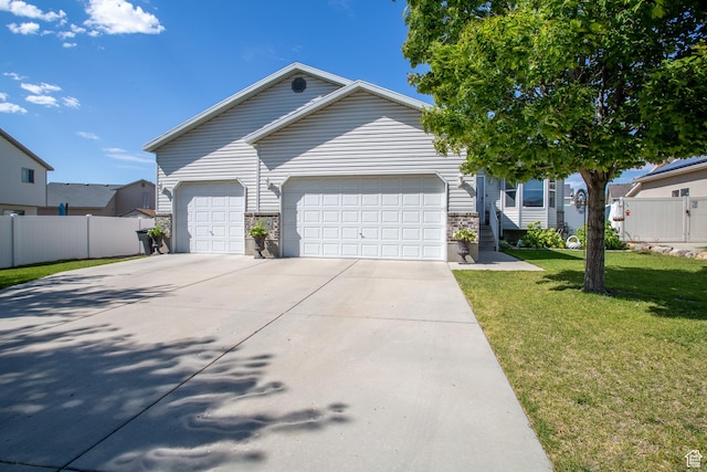 single story home featuring fence, driveway, a front yard, and a garage