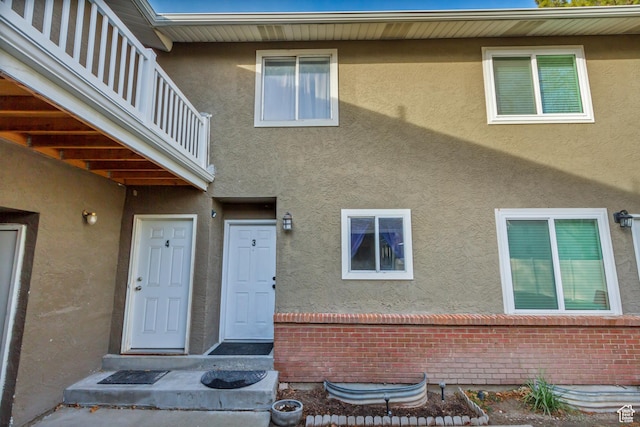 5235 S Glendon St W Unit W3, Salt Lake City, UT 84123 - property entrance with stucco siding, brick siding, and a balcony