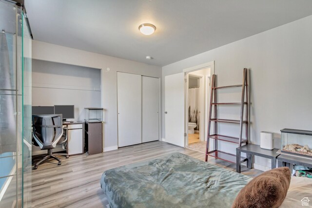 5235 S Glendon St W Unit W3, Salt Lake City, UT 84123 - bedroom featuring wood finished floors, a desk, baseboards, and ensuite bath