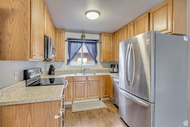 5235 S Glendon St W Unit W3, Salt Lake City, UT 84123 - kitchen with stainless steel appliances, a sink, light countertops, and light wood-type flooring