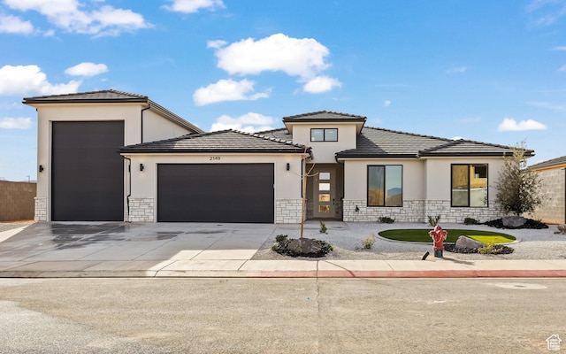 2149 W 3930 S, Hurricane, UT 84737 - prairie-style house with an attached garage, stucco siding, stone siding, driveway, and a tile roof