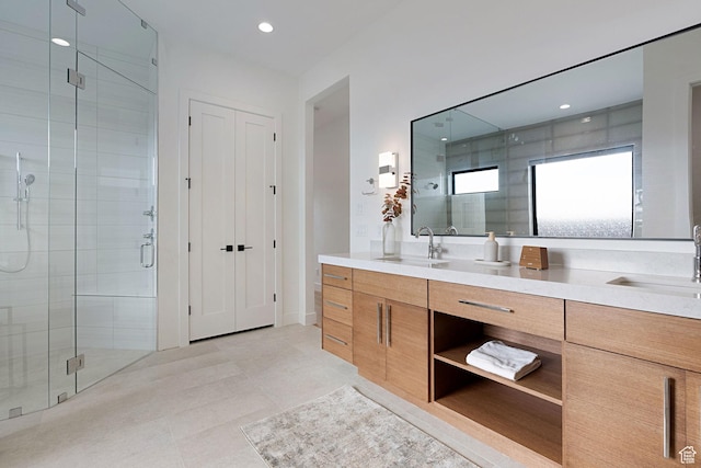 bathroom with tile patterned floors, vanity, and walk in shower