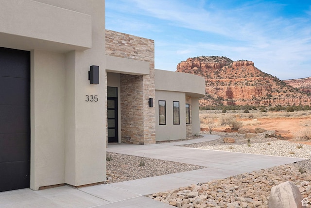 view of exterior entry featuring a mountain view