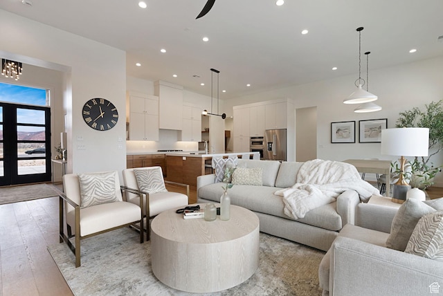 living room with light wood-type flooring and ceiling fan