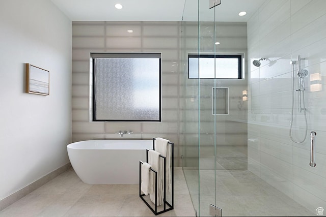 bathroom featuring tile patterned floors and independent shower and bath