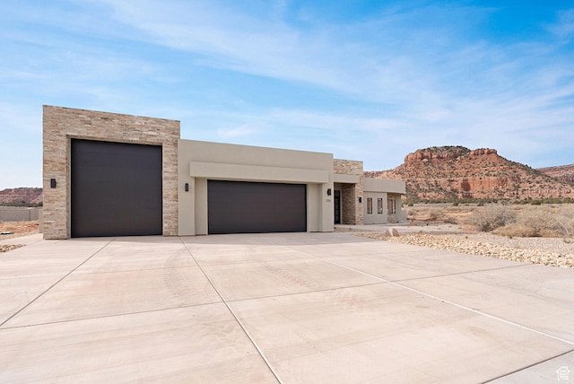 view of front facade with a mountain view and a garage