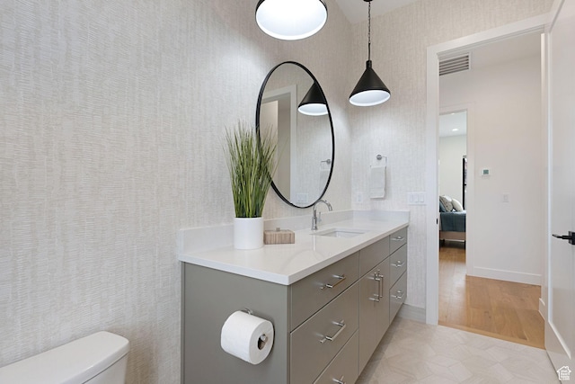bathroom with vanity and toilet