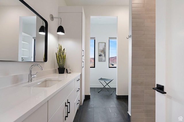 bathroom with tile patterned floors and vanity