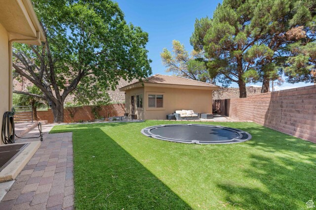 2712 S Rio Vista Dr, St George, UT 84790 - view of yard with an outdoor hangout area, a trampoline, and a patio