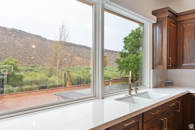 2712 S Rio Vista Dr, St George, UT 84790 - kitchen with a mountain view, sink, and light stone counters